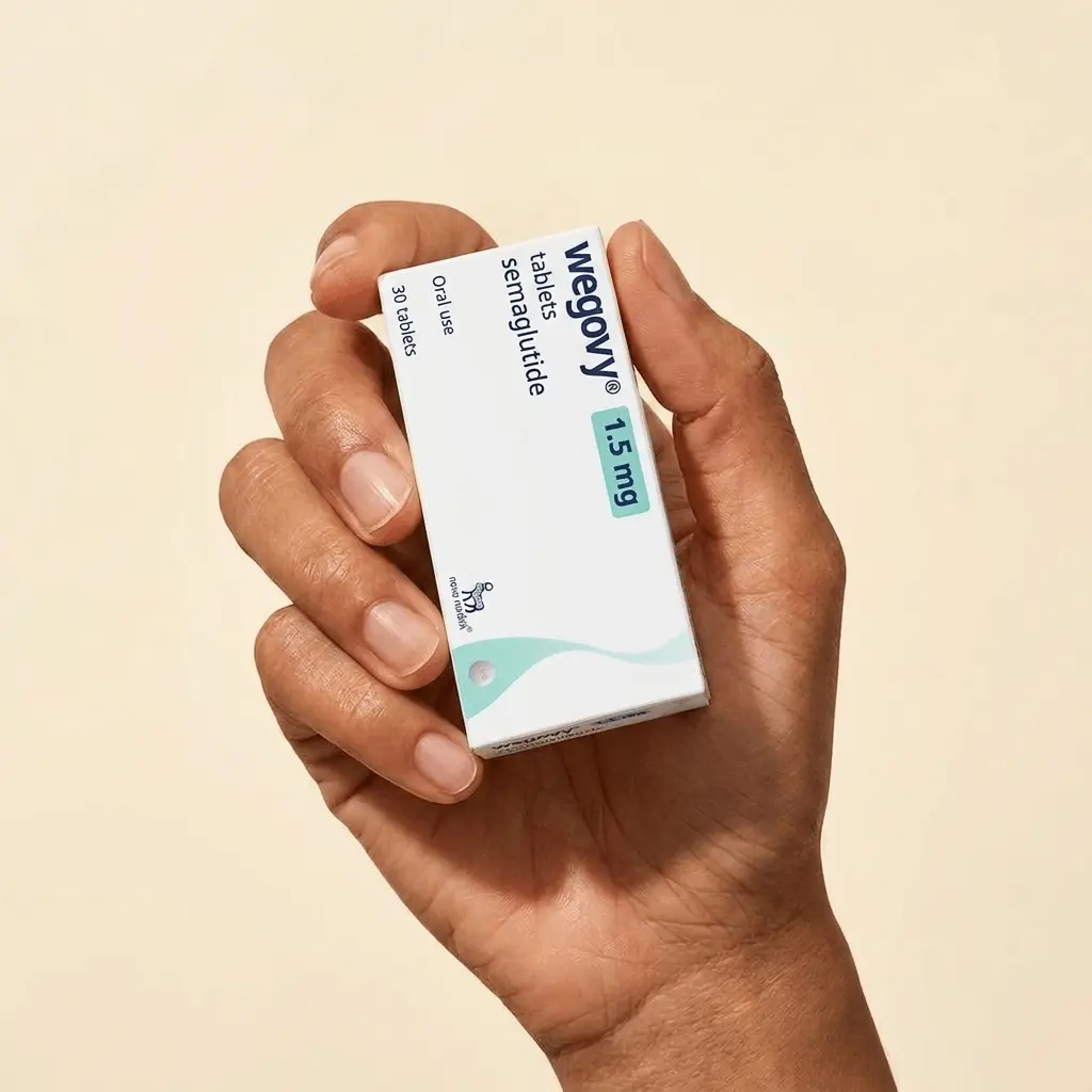 Hand holding a bottle of Wegovy semaglutide tablets